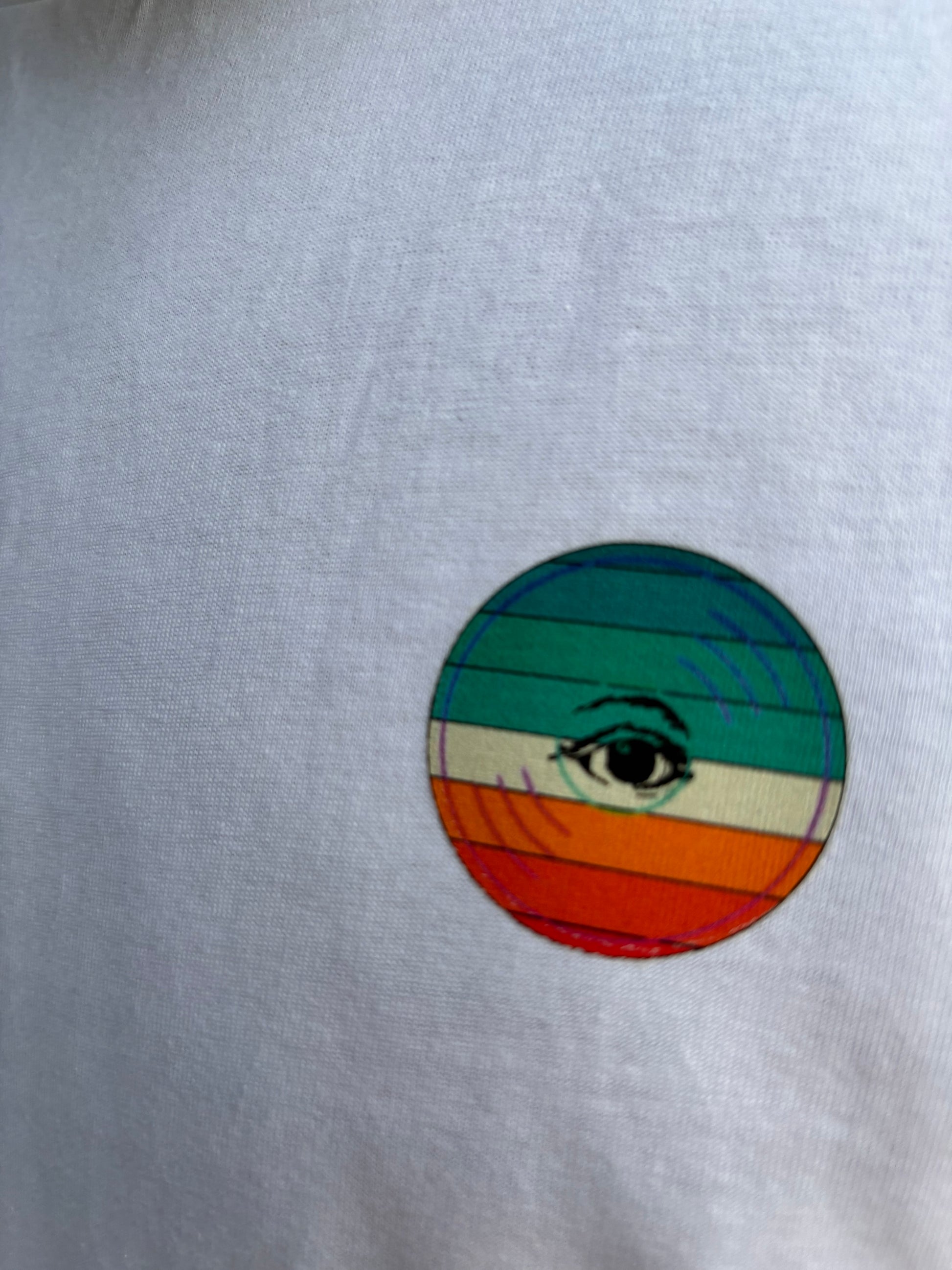 Colorful circular design with a central eye symbol on a white background