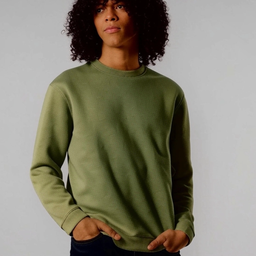 Person wearing a green sweatshirt against a plain background